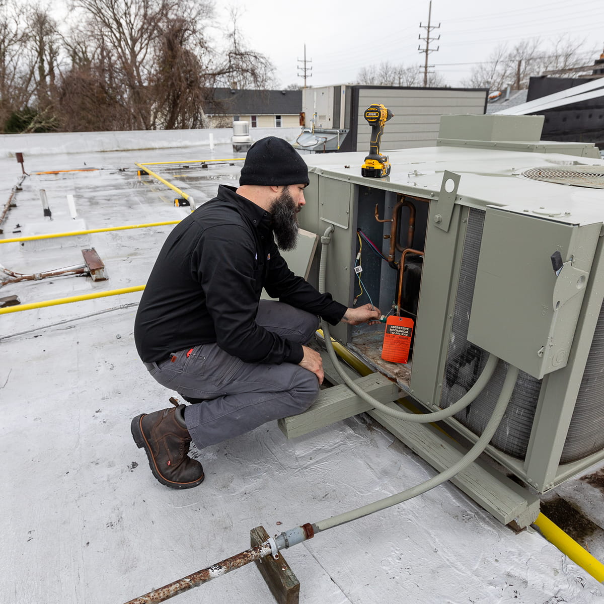 Technician performing commercial AC maintenance service