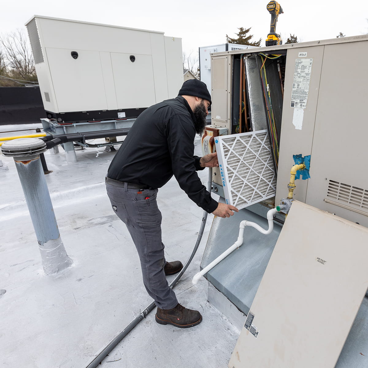 Technician performing maintenance on a commercial heating system