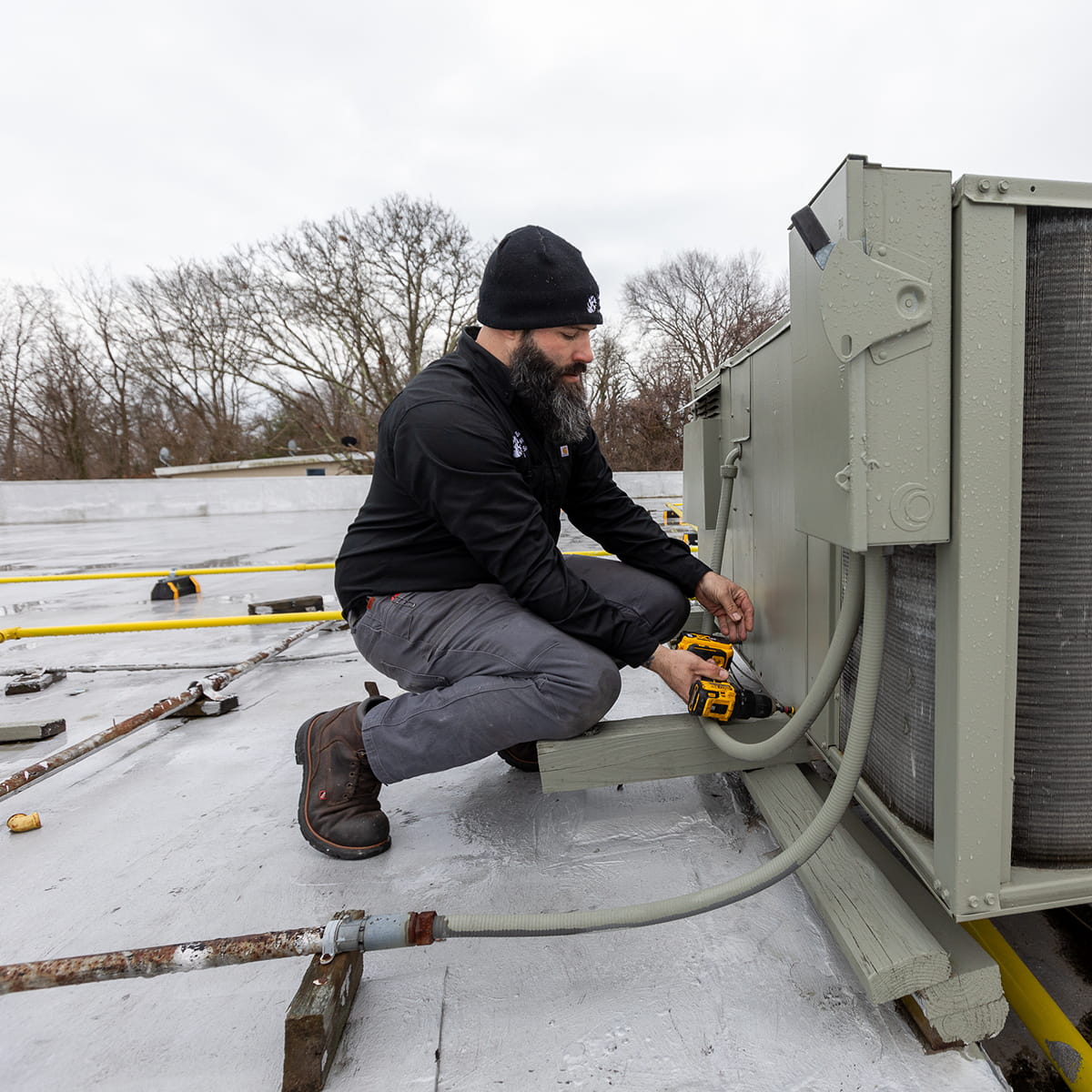 Technician repairing commercial air conditioner